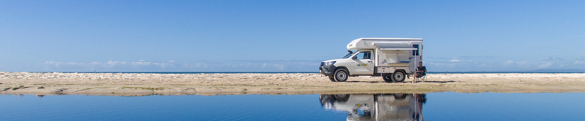 Talvor adventure camper on sand near ocean