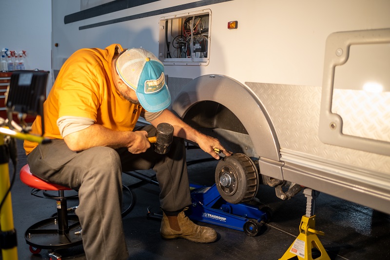 RV technician working on a vehicle